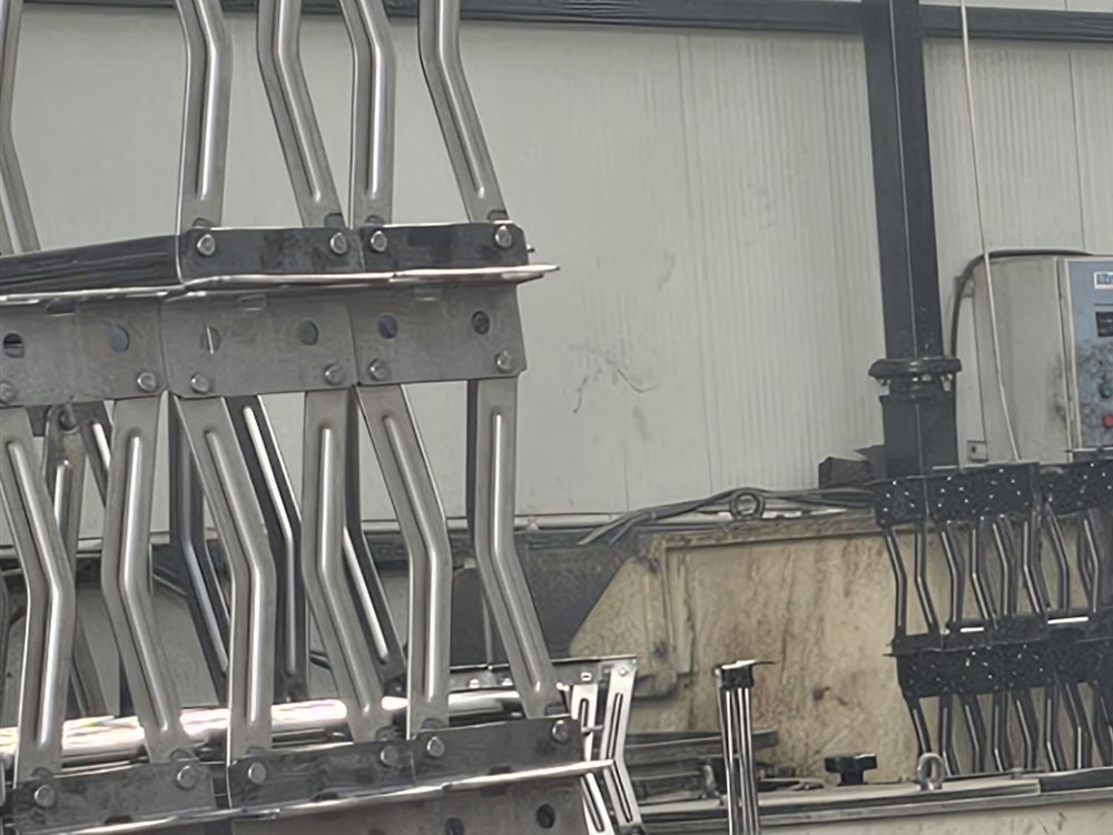 Stacked welded scissor-arm assemblies