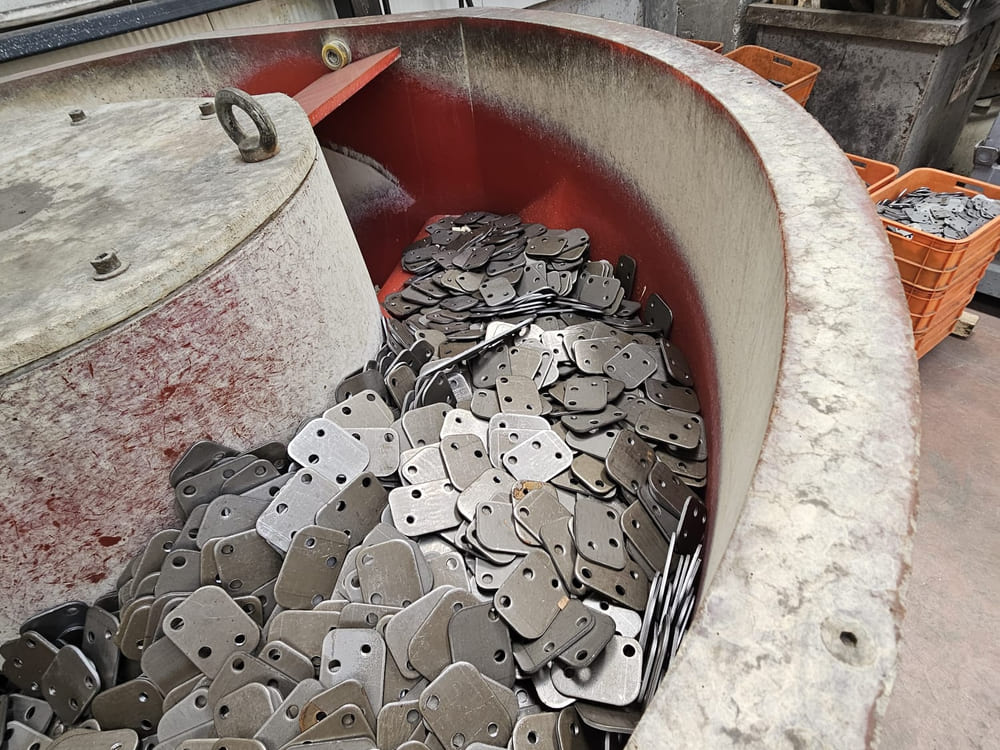 Finishing bowl with crates of completed parts alongside